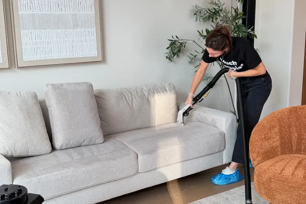 Professional couch cleaning service in Charlotte NC cleaning a fabric sofa