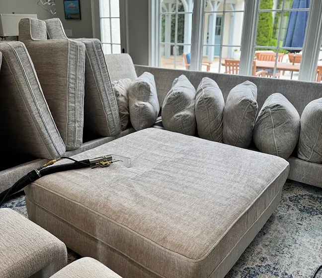 Sectional couch cleaning in Dallas removing dirt, stains, and pet hair from fabric sofa