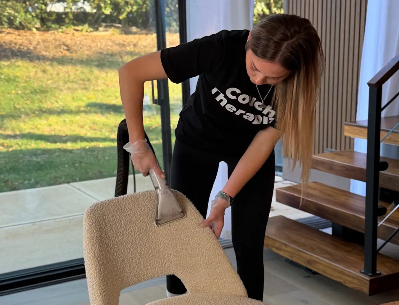 Upholstery cleaning technician removing stains from a chair in a Charlotte home